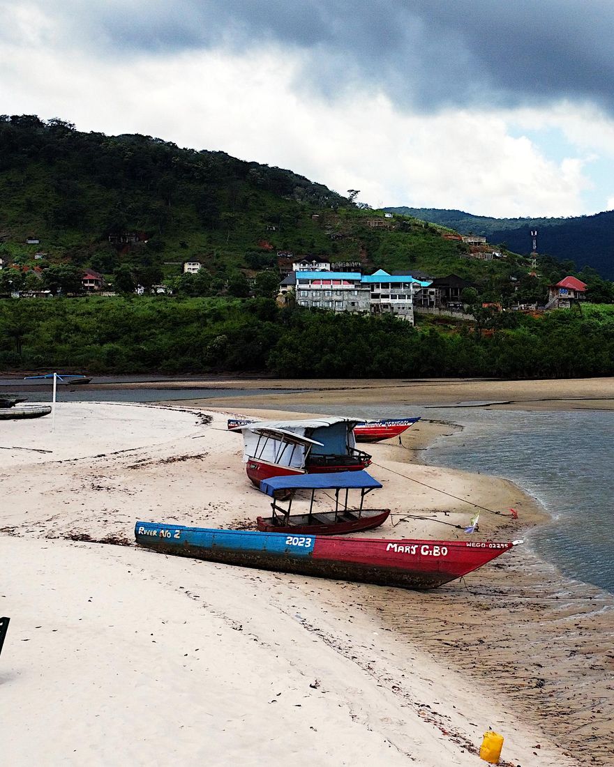 Painted boats pulled up on the sand at River Number 2 beach