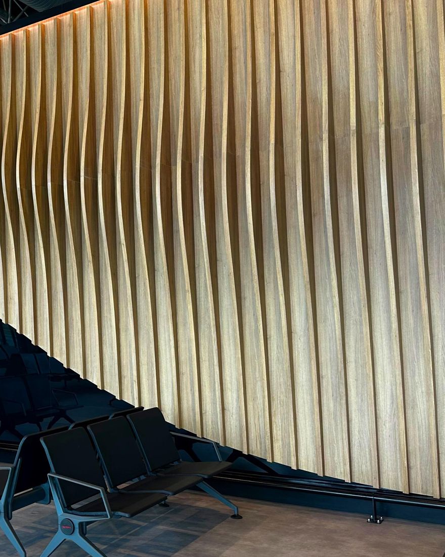 The wave-shaped wooden wall inside Freetown International Airport